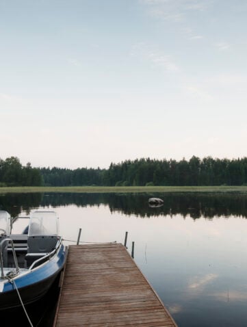 View of boat, pier and lake mid summer