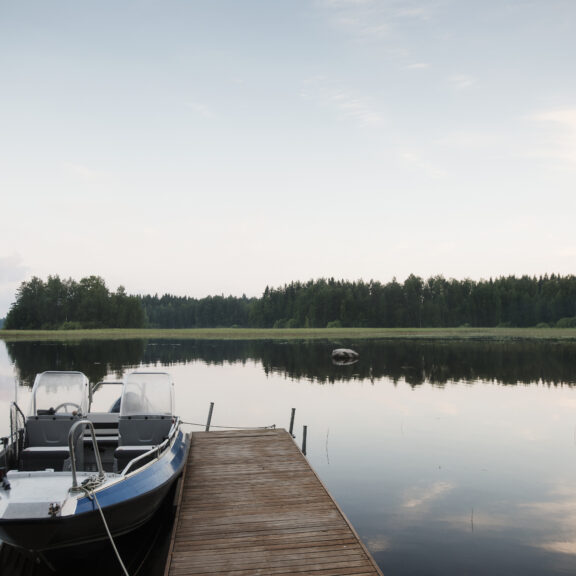 View of boat, pier and lake mid summer