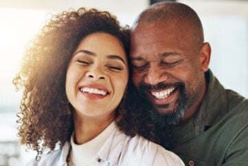 A happy couple embracing and laughing