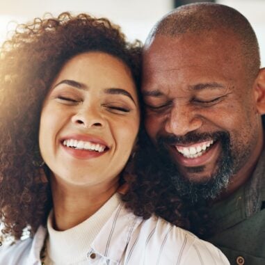 A happy couple embracing and laughing